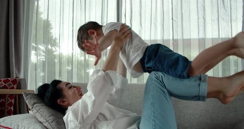 Mother and Child Playing Together on Couch