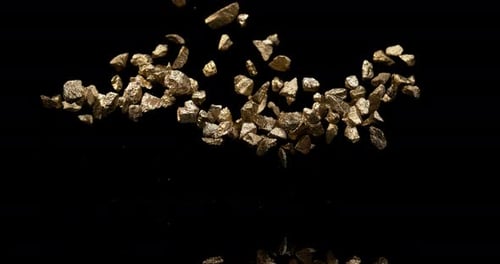 Gold Nuggets Exploding Against a Black Background