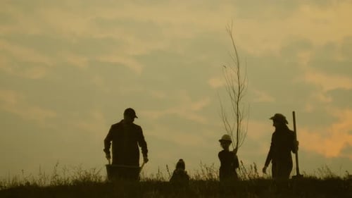 Young Family Having Fun Outdoors in Their Farm. Silhouette Family of Four Planting a New Tree at