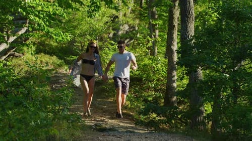 Couple running in a forest park