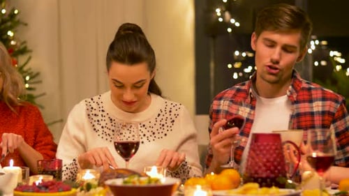 Friends Gather for Christmas Dinner Celebration Indoors