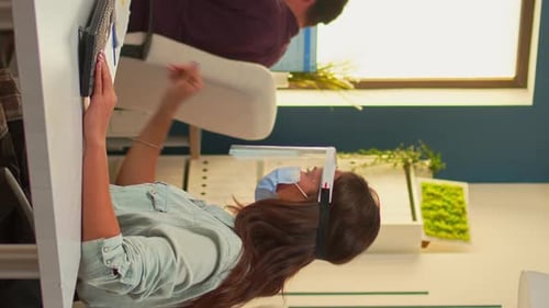 Office Workers Reviewing Information Wearing PPE Gear