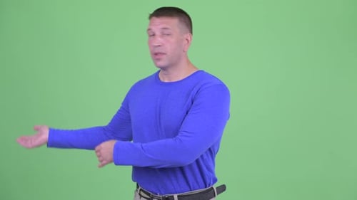 Confident Man Gesturing on Chroma Key Background
