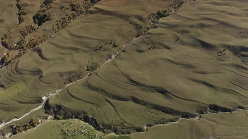 Aerial View of Rolling Grassy Hills and Valleys