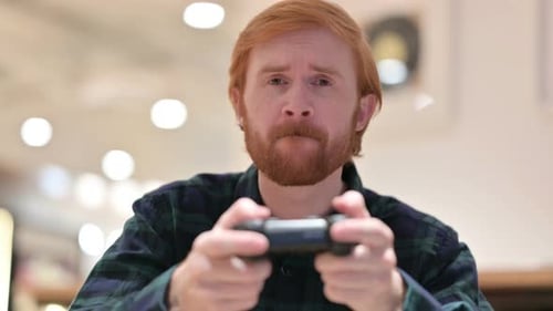 Red Haired Man Playing Video Game With Controller