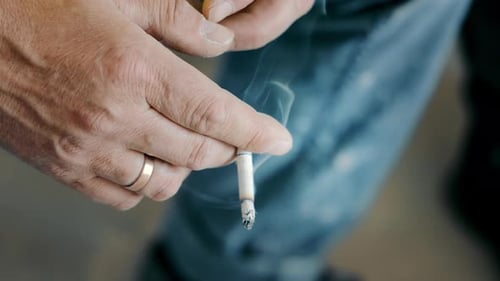 person holding cigarette Ultra-realistic close-up of a human hand a lit with visible natural skin texture, soft lighting, and a shallow depth of field 4,605 Man Holding Cigarette Stock
