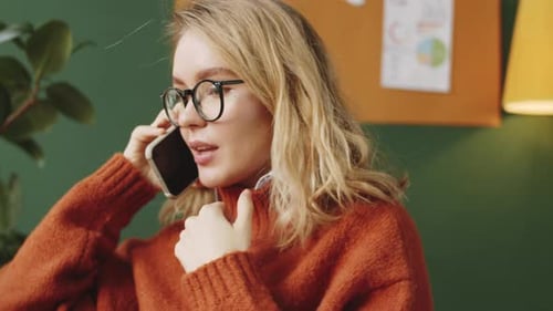 Young Woman Talking on Cellphone in Office