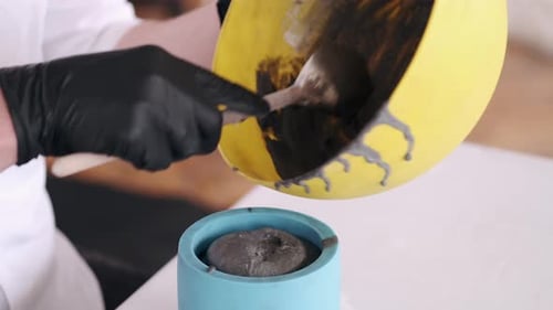Viscous Mixture Poured into Mold by Gloved Hand