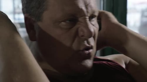 Adult Man Doing Sit Ups in Gym