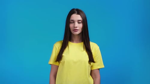 Woman in Yellow Shirt on Blue Background