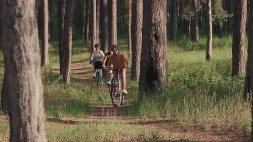 Happy Family Cycling In Woods