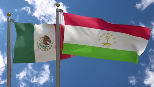 Waving Mexican and Tajik Flags against Blue Sky for International Relations