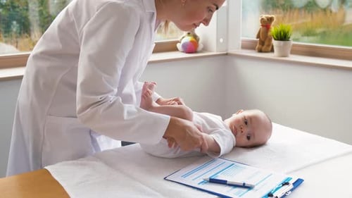 Female Pediatrician Doctor with Baby at Clinic