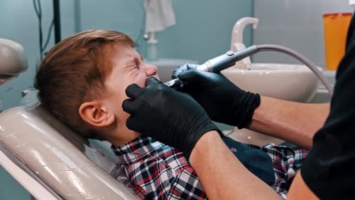 Child Getting Teeth Examined at Dentist Office