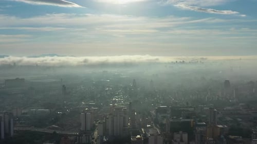 Above the clouds. Sunrise foggy morning at downtown city.