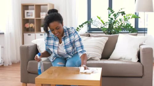 Woman Cleans Table in Bright Modern Home