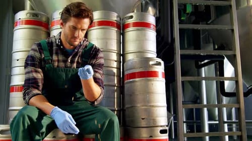 Brewer checking grains 4k
