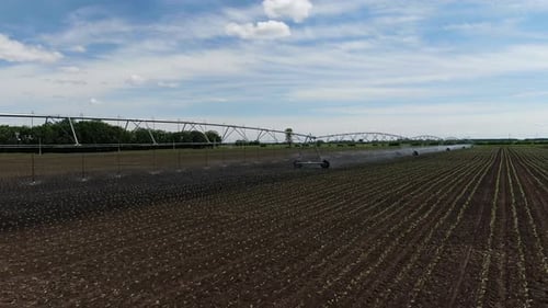Drone Footage of the Sprinkling Machine in the Field Watering the Plants,