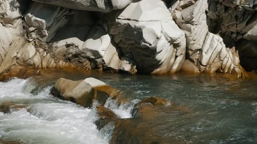 Wild Mountain River Flowing with Stone Boulders and Rapids