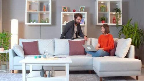 Man and Woman Relaxing at Home with Laptop