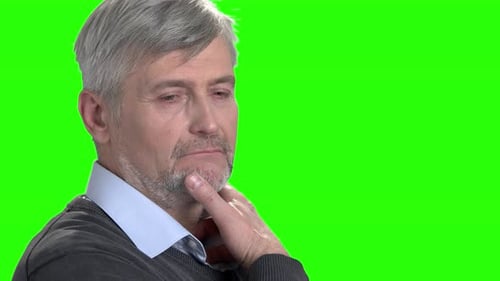 Mature Man Resting Chin on Hand, Green Screen