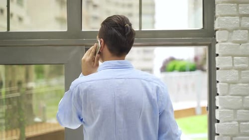 Young business man making a phone call in the office.