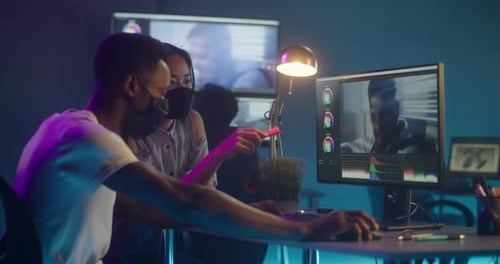 Creative Teamwork Editing Video in Modern Office