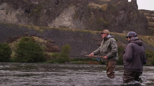 Men Fly Fishing in Cold River in Nature