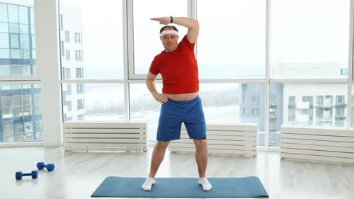 Young Funny Fat Sporty Man Stretching Before Exercise