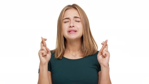 Portrait of Concentrated Woman Dressed in Green Shirt Willing Good Luck Pleading with Keeping