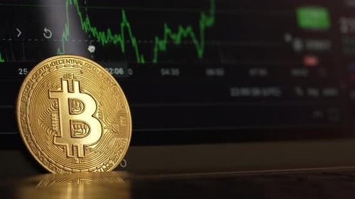 Macro of Golden Bitcoin in Front of Financial Chart