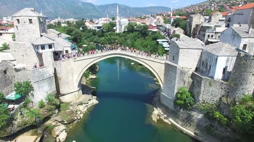 Aerial view of people walking over bridge in Mostar, Bosnia.