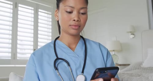 Young female nurse using smartphone