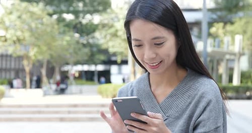 Woman use of smart phone in city