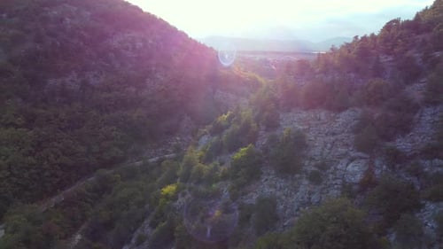 Aerial shot of an amazing green valley in between huge mountains