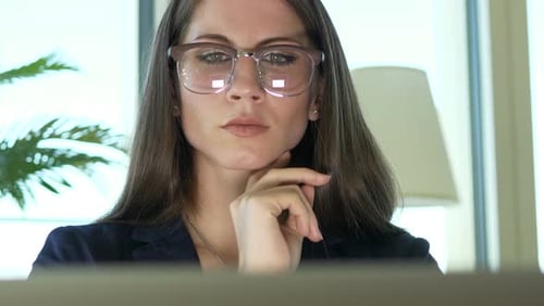 Attractive Business Woman Working in Office on Computer Desk
