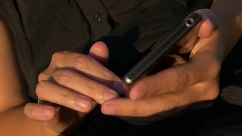 Woman's Hands Holding and Using Mobile Smart Phone