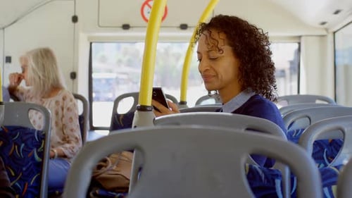 Woman Uses Phone on City Bus