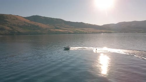 Sunny Summer Day Aerial Of Wakeboarding Behind Boat On Lake Chelan