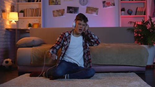 Teenage Boy Listening to Music at Home