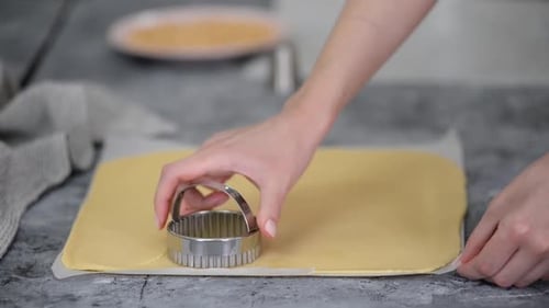 Cutting Out Round Shapes From Rolled Out Dough to Prepare Homemade Cookies