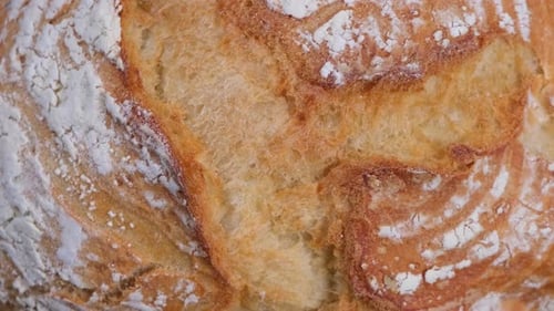 Background of Rotating Ruddy Fresh White Bread Top View Closeup