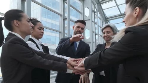 Business people stacking hands