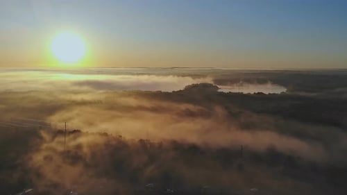 Aerial View of Foggy Landscape at Sunrise