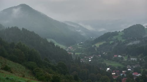 Misty morning in a mountain village, A vanishing fog revealing a settlement in the valley