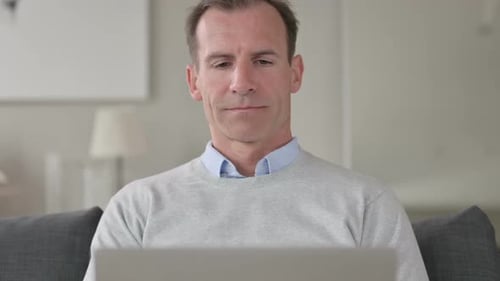 Adult Man Using Laptop Computer Indoors