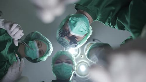 Medical Surgeons Team Performing Surgical Operation in Modern Operating medical Room at hospital.