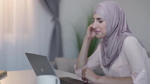 Stylish Woman Talking at Laptop While at Home