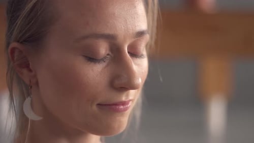 Young Woman Makes Yoga in Her Home Studio