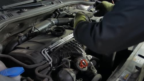 Mechanic Hands Working on Engine in Industrial Setting